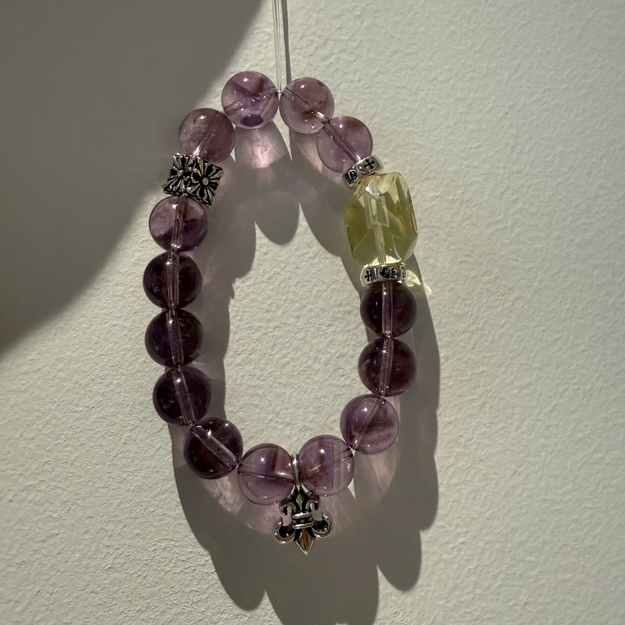 This is a crystal bracelet that consists of amethyst, citrine and chrome hearts spacers.