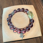 This is a crystal bracelet that consists of amethyst, citrine and chrome hearts spacers.