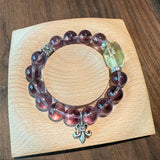 This is a crystal bracelet that consists of amethyst, citrine and chrome hearts spacers.