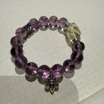 This is a crystal bracelet that consists of amethyst, citrine and chrome hearts spacers.