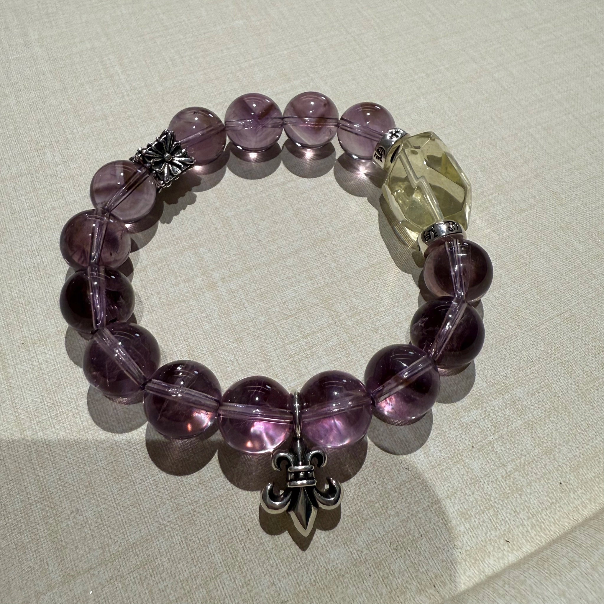 This is a crystal bracelet that consists of amethyst, citrine and chrome hearts spacers.