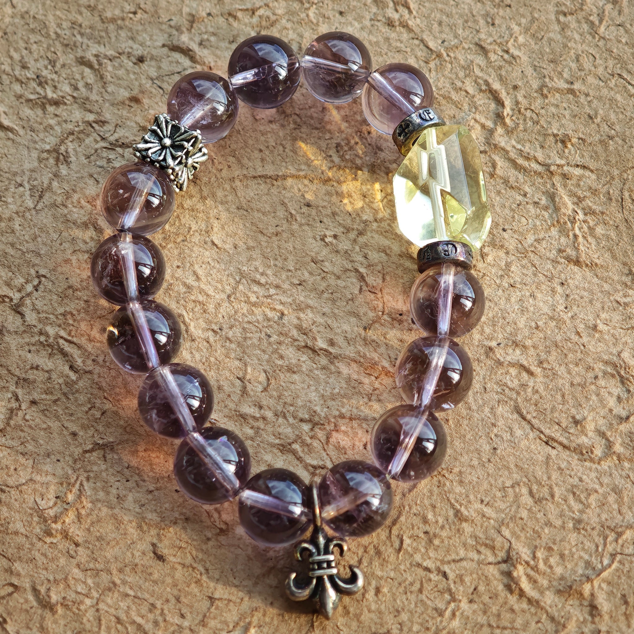 This is a crystal bracelet that consists of amethyst, citrine and chrome hearts spacers.