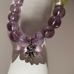 This is a crystal bracelet that consists of amethyst, citrine and chrome hearts spacers.