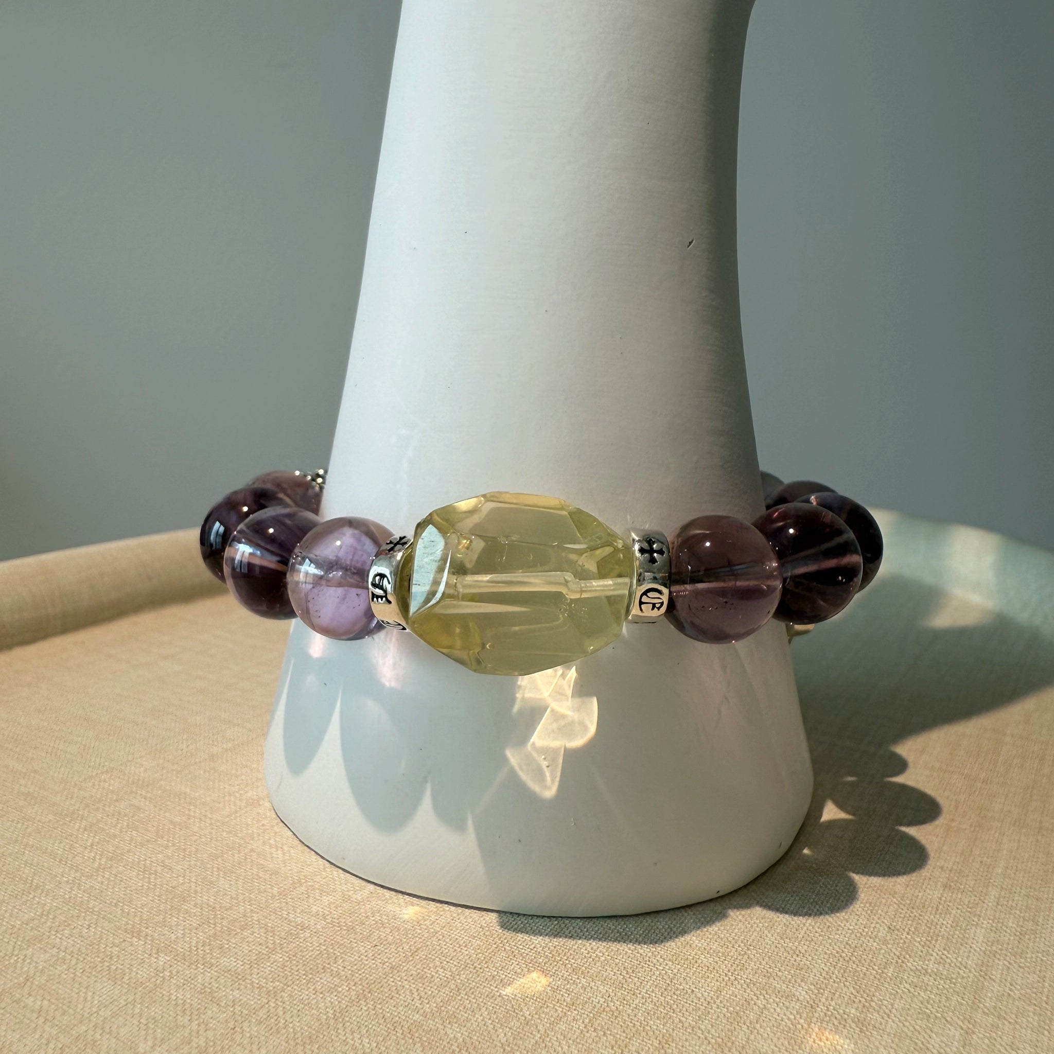 This is a crystal bracelet that consists of amethyst, citrine and chrome hearts spacers.