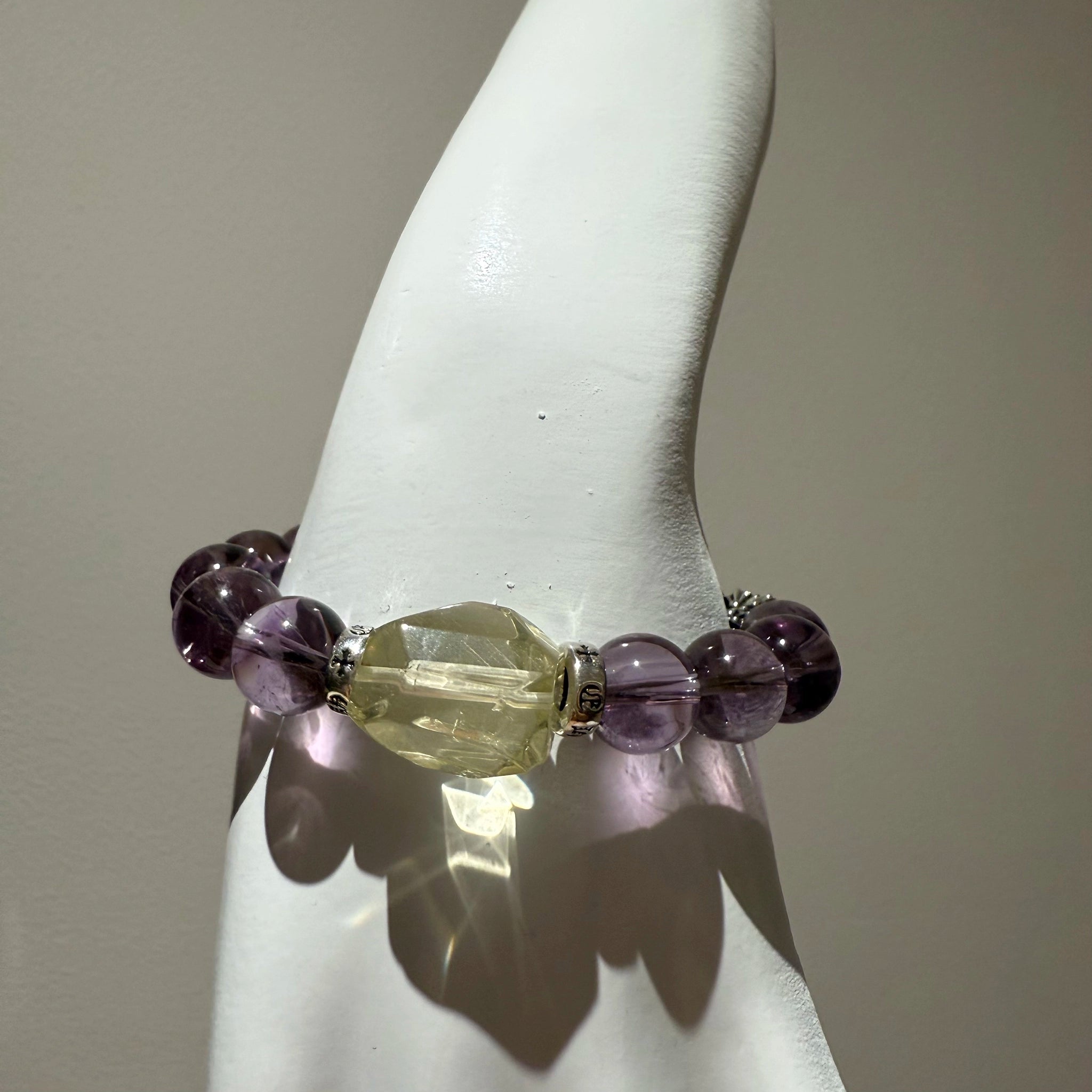 This is a crystal bracelet that consists of amethyst, citrine and chrome hearts spacers.