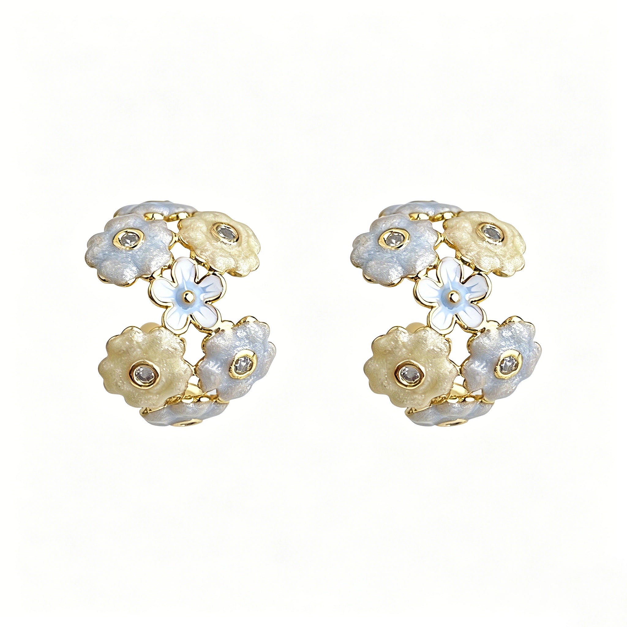 These 18k gold-plated stud/clip earrings feature delicate blossoms crafted with enamel glaze and inlaid with sparkling zircon stones. The combination of soft blue, creamy yellow and lustrous gold creates a romantic and feminine look that captures the essence of blooming florals.