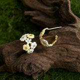 These 18k gold-plated stud/clip earrings feature delicate blossoms crafted with enamel glaze and inlaid with sparkling zircon stones. The combination of soft blue, creamy yellow and lustrous gold creates a romantic and feminine look that captures the essence of blooming florals.
