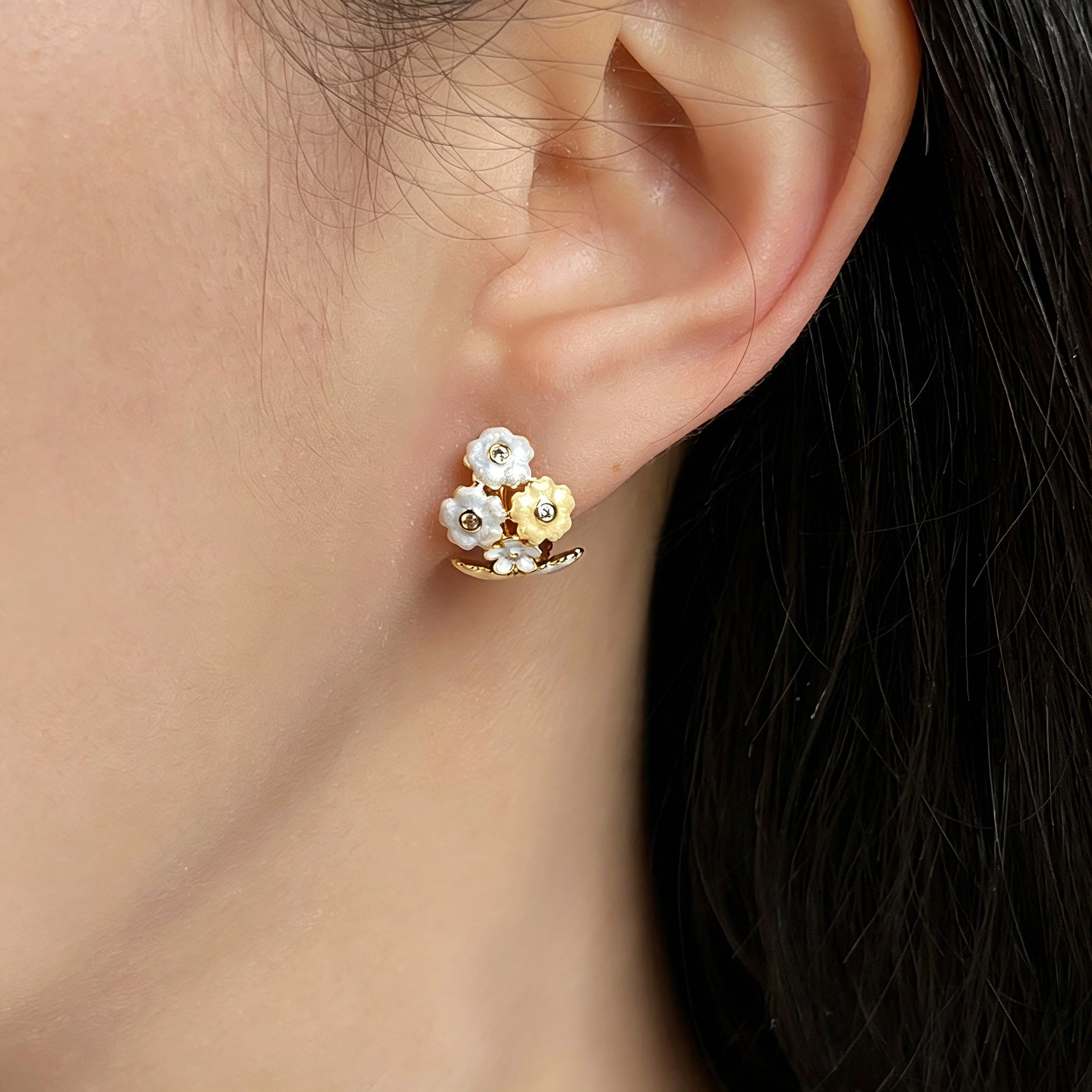 These 18k gold-plated stud/clip earrings feature delicate blossoms crafted with enamel glaze and inlaid with sparkling zircon stones. The combination of soft blue, creamy yellow and lustrous gold creates a romantic and feminine look that captures the essence of blooming florals.