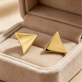 These thick 18K gold-plated stud earrings feature a sleek, modern curved triangle design with smooth, polished surfaces that catch the light beautifully. The sculpted, slightly concave shape creates a three-dimensional effect, adding subtle depth and dimension to the minimalist geometric silhouette.