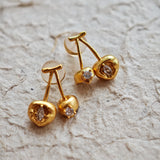 These cherry-shaped stud earrings feature a luxurious matte sandblasted finish, crafted from thick-plated real gold over 925 sterling silver posts. Each earring is designed as a pair of cherries, adorned with a marquise-cut and a round-cut sparkling clear stone, adding a delicate, eye-catching sparkle. The playful, organic cherry silhouette and premium gold plating make them a chic, elegant accessory for everyday wear.