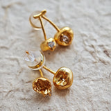 These cherry-shaped stud earrings feature a luxurious matte sandblasted finish, crafted from thick-plated real gold over 925 sterling silver posts. Each earring is designed as a pair of cherries, adorned with a marquise-cut and a round-cut sparkling clear stone, adding a delicate, eye-catching sparkle. The playful, organic cherry silhouette and premium gold plating make them a chic, elegant accessory for everyday wear.