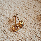 These cherry-shaped stud earrings feature a luxurious matte sandblasted finish, crafted from thick-plated real gold over 925 sterling silver posts. Each earring is designed as a pair of cherries, adorned with a marquise-cut and a round-cut sparkling clear stone, adding a delicate, eye-catching sparkle. The playful, organic cherry silhouette and premium gold plating make them a chic, elegant accessory for everyday wear.