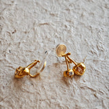 These cherry-shaped stud earrings feature a luxurious matte sandblasted finish, crafted from thick-plated real gold over 925 sterling silver posts. Each earring is designed as a pair of cherries, adorned with a marquise-cut and a round-cut sparkling clear stone, adding a delicate, eye-catching sparkle. The playful, organic cherry silhouette and premium gold plating make them a chic, elegant accessory for everyday wear.