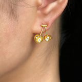 These cherry-shaped stud earrings feature a luxurious matte sandblasted finish, crafted from thick-plated real gold over 925 sterling silver posts. Each earring is designed as a pair of cherries, adorned with a marquise-cut and a round-cut sparkling clear stone, adding a delicate, eye-catching sparkle. The playful, organic cherry silhouette and premium gold plating make them a chic, elegant accessory for everyday wear.