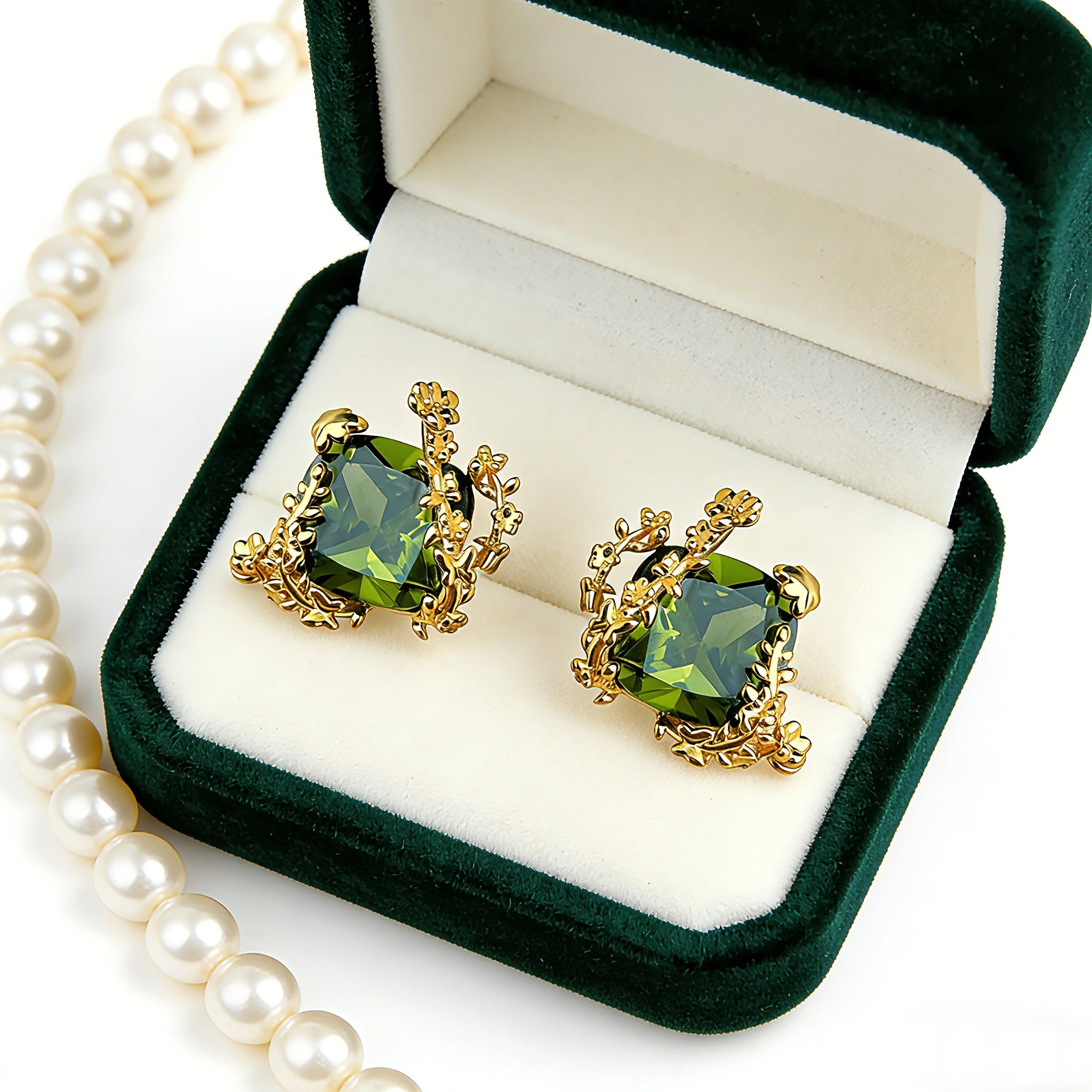 These stud earrings feature cushion-cut olive-green cubic zirconia stones, each encircled by delicate, nature-inspired gold floral and vine detailing. The thick 18K gold plating lends a rich, warm luster, contrasting beautifully with the deep green cubic zirconia to create an elegant, botanical aesthetic.