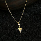This is a necklace featuring a unique shovel-shaped pendant crafted with thick 18K gold plating, exuding a luxurious golden luster. The pendant is adorned with delicate micro-paved cubic zirconia stones, which sparkle brightly against the gold surface. Designed as a dainty pendant necklace, it showcases a sleek, minimalist style with intricate detailing on the shovel head and handle.