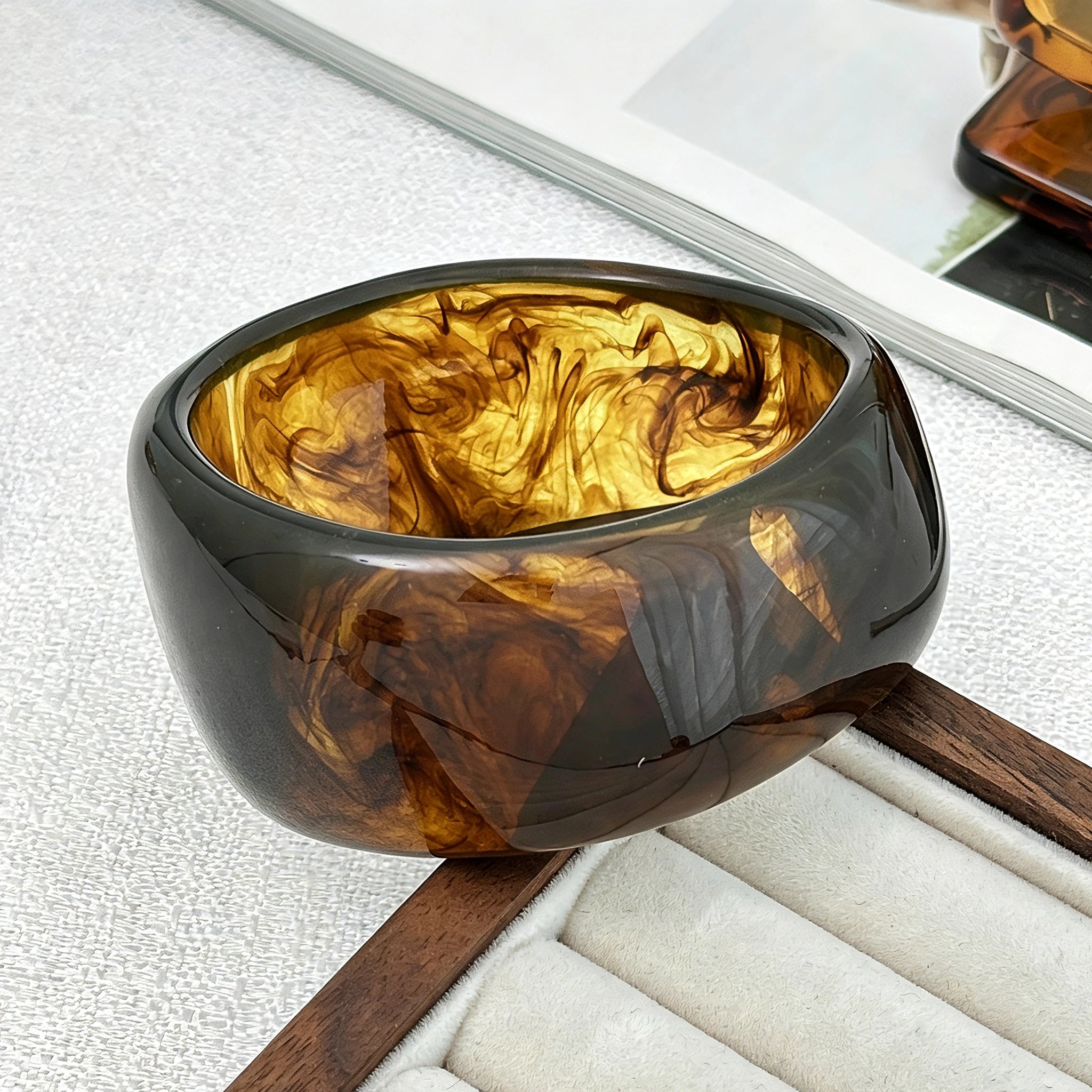 Crafted from translucent acrylic, these amber marbled bangles feature organic swirling tones for a vintage aesthetic. The 3-piece set includes varied shapes that stack beautifully, adding earthy retro charm to any outfit. Smooth, polished surfaces deliver a lightweight, comfortable wearing experience.