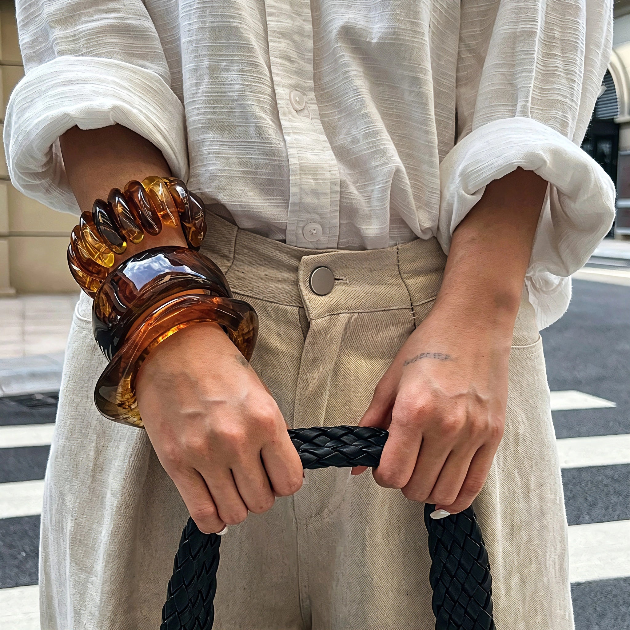 Crafted from translucent acrylic, these amber marbled bangles feature organic swirling tones for a vintage aesthetic. The 3-piece set includes varied shapes that stack beautifully, adding earthy retro charm to any outfit. Smooth, polished surfaces deliver a lightweight, comfortable wearing experience.