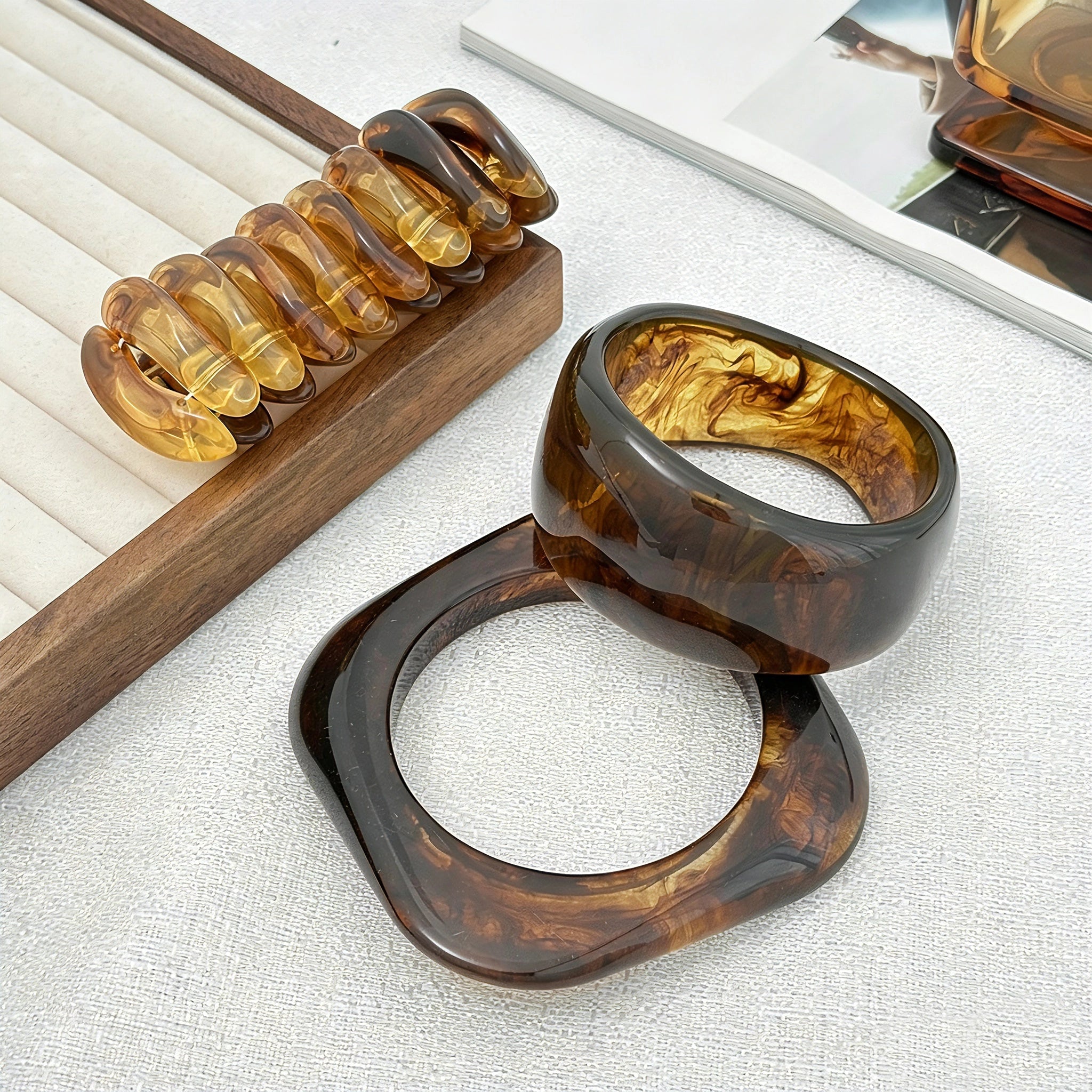 Crafted from translucent acrylic, these amber marbled bangles feature organic swirling tones for a vintage aesthetic. The 3-piece set includes varied shapes that stack beautifully, adding earthy retro charm to any outfit. Smooth, polished surfaces deliver a lightweight, comfortable wearing experience.