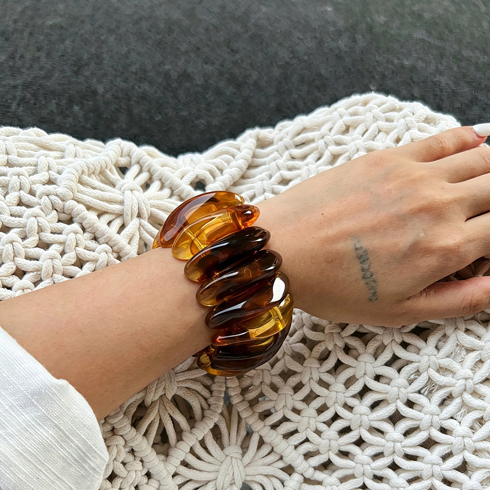 Crafted from translucent acrylic, these amber marbled bangles feature organic swirling tones for a vintage aesthetic. The 3-piece set includes varied shapes that stack beautifully, adding earthy retro charm to any outfit. Smooth, polished surfaces deliver a lightweight, comfortable wearing experience.