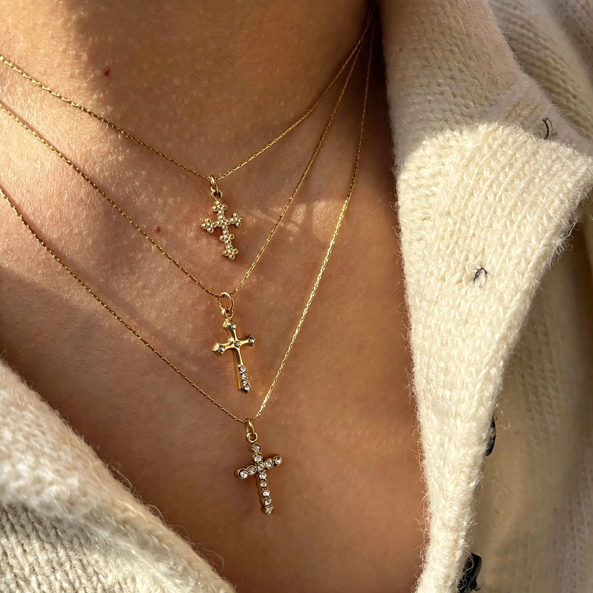 This 3-piece stainless steel cross necklace set features three distinct cross pendants, including crystal-encrusted styles and an ornate floral cross. Crafted in polished gold tone, the delicate thin chains are perfect for trendy layered stacking looks. Waterproof and durable, these dainty cross necklaces deliver timeless vintage charm for everyday wear.