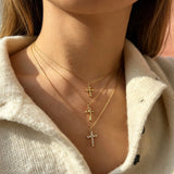 This 3-piece stainless steel cross necklace set features three distinct cross pendants, including crystal-encrusted styles and an ornate floral cross. Crafted in polished gold tone, the delicate thin chains are perfect for trendy layered stacking looks. Waterproof and durable, these dainty cross necklaces deliver timeless vintage charm for everyday wear.