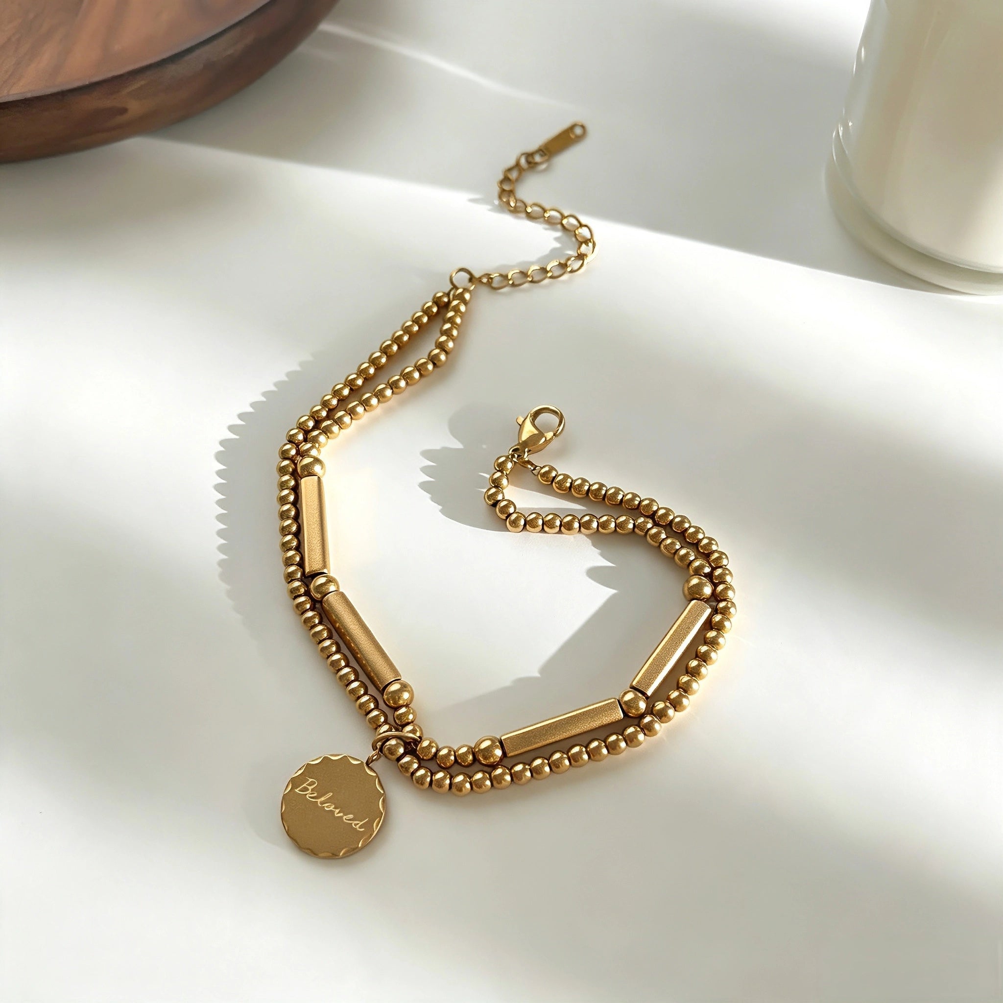 This vintage-inspired 3-piece bracelet set features a wavy gold bangle, engraved stainless steel bead chain and mixed black braided cord bracelet. Crafted from durable stainless steel, this stackable jewelry delivers timeless east-meets-west aesthetics for effortless layered styling. It is a versatile everyday accessory to elevate casual and chic outfits.