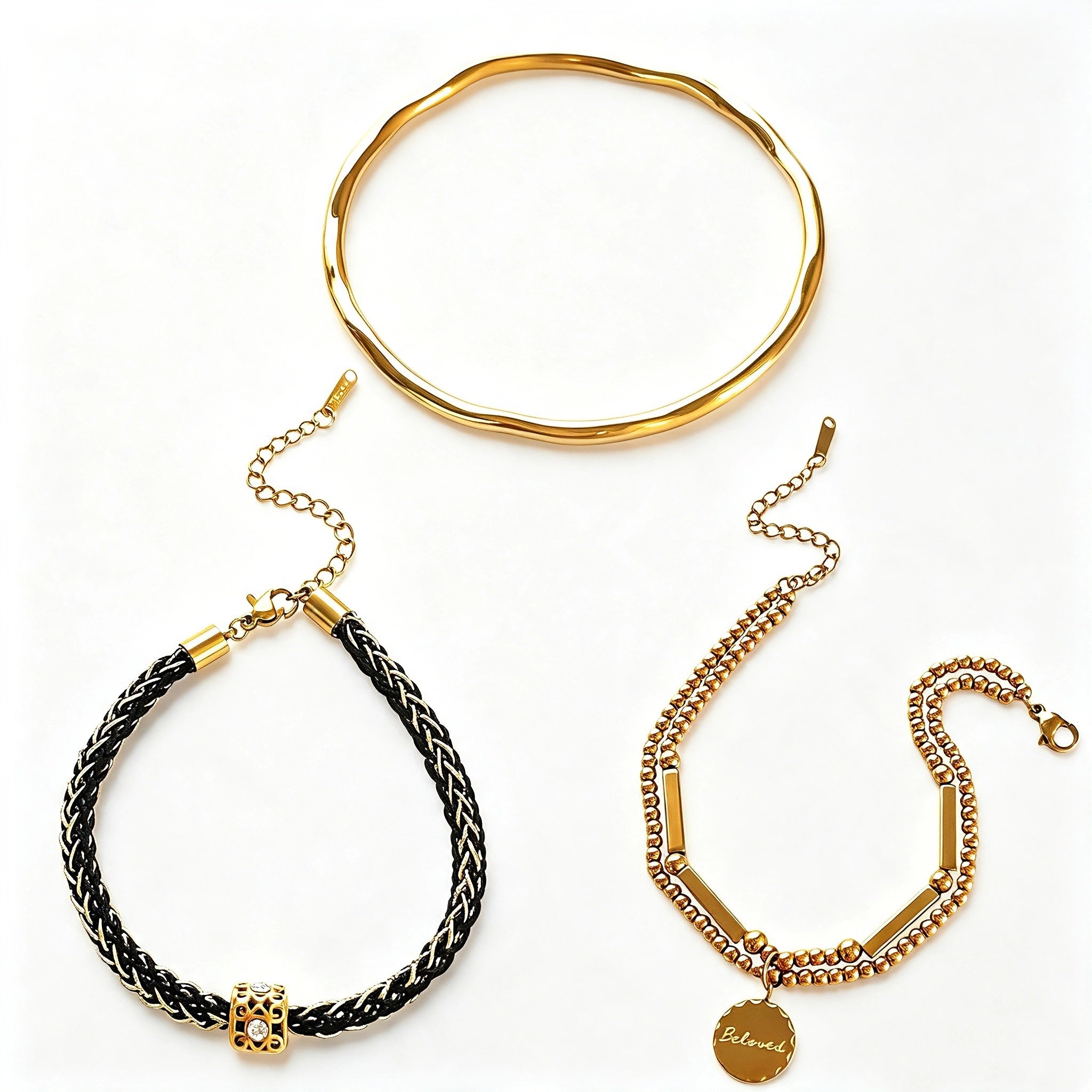 This vintage-inspired 3-piece bracelet set features a wavy gold bangle, engraved stainless steel bead chain and mixed black braided cord bracelet. Crafted from durable stainless steel, this stackable jewelry delivers timeless east-meets-west aesthetics for effortless layered styling. It is a versatile everyday accessory to elevate casual and chic outfits.