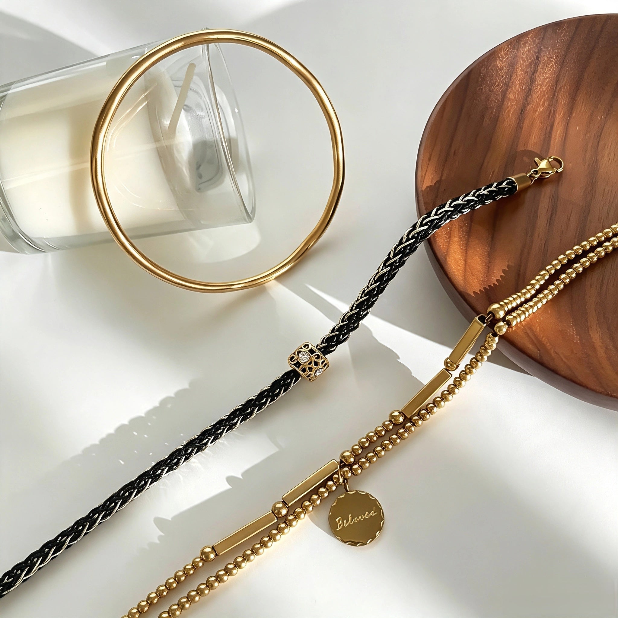 This vintage-inspired 3-piece bracelet set features a wavy gold bangle, engraved stainless steel bead chain and mixed black braided cord bracelet. Crafted from durable stainless steel, this stackable jewelry delivers timeless east-meets-west aesthetics for effortless layered styling. It is a versatile everyday accessory to elevate casual and chic outfits.
