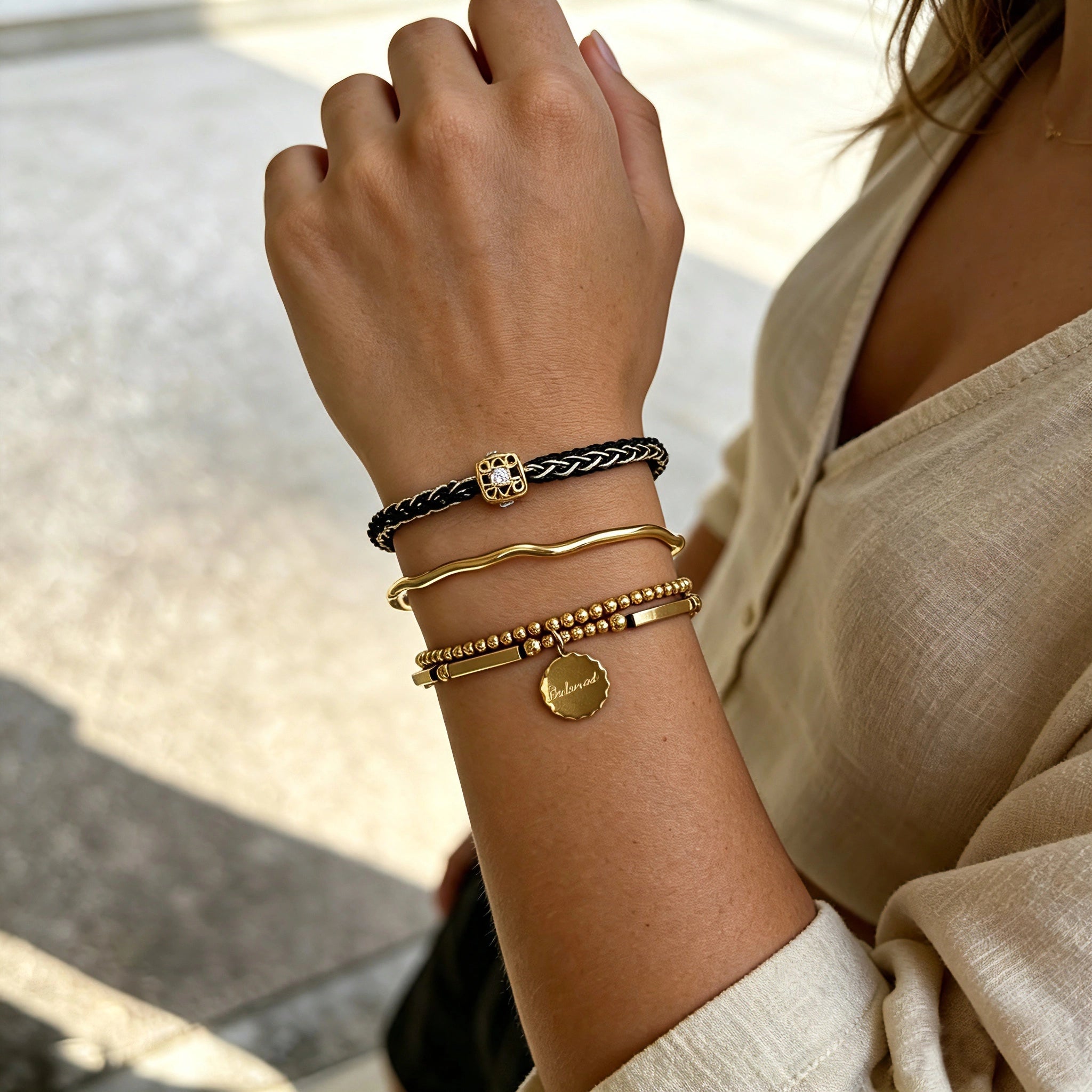 This vintage-inspired 3-piece bracelet set features a wavy gold bangle, engraved stainless steel bead chain and mixed black braided cord bracelet. Crafted from durable stainless steel, this stackable jewelry delivers timeless east-meets-west aesthetics for effortless layered styling. It is a versatile everyday accessory to elevate casual and chic outfits.