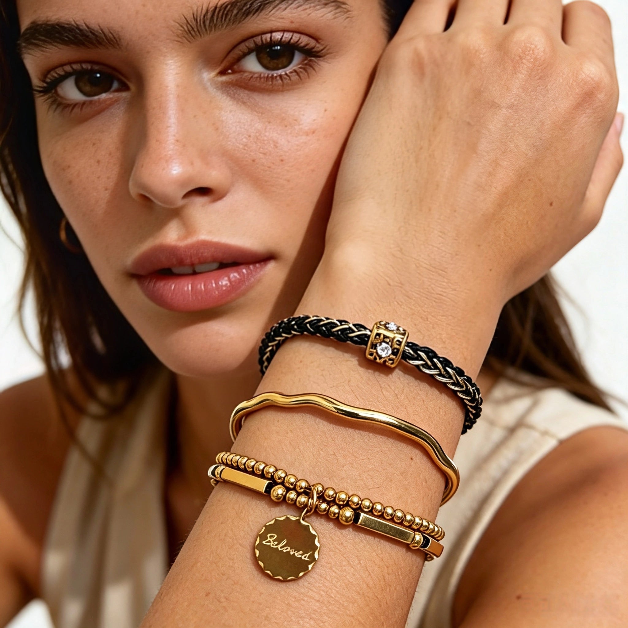 This vintage-inspired 3-piece bracelet set features a wavy gold bangle, engraved stainless steel bead chain and mixed black braided cord bracelet. Crafted from durable stainless steel, this stackable jewelry delivers timeless east-meets-west aesthetics for effortless layered styling. It is a versatile everyday accessory to elevate casual and chic outfits.