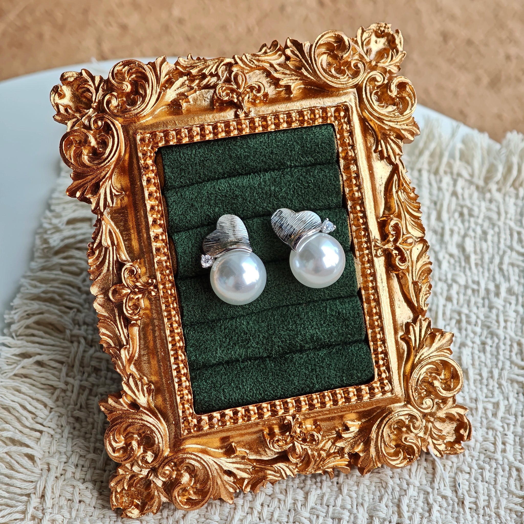 This minimalist pair of silver pearl stud earrings cleverly combine a chic silver heart-shaped pendant (11.7 mm wide) with a striking pearl teardrop (total height: 19.4 mm), with the pearl beneath the heart, creating a unique and stylish silhouette.