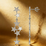 These 925 sterling silver tassel earrings showcase a star-themed design with multiple dangling stars of different sizes. Sparkling moissanite embellishments adorn some star surfaces, enhancing their luxurious and eye-catching appearance. The tassel-style structure creates a graceful, flowing silhouette with a dynamic, elegant look.