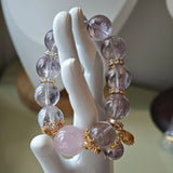 This is a bracelet featuring high-clarity amethyst, rose quartz, and citrine. It's an elegant look of pure peace.