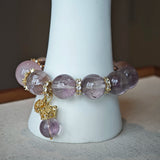 This is a bracelet featuring high-clarity amethyst, rose quartz, and citrine. It's an elegant look of pure peace.