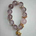 This is a bracelet featuring high-clarity amethyst, rose quartz, and citrine. It's an elegant look of pure peace.