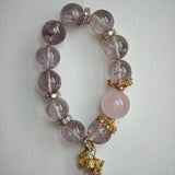 This is a bracelet featuring high-clarity amethyst, rose quartz, and citrine. It's an elegant look of pure peace.