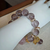 This is a bracelet featuring high-clarity amethyst, rose quartz, and citrine. It's an elegant look of pure peace.