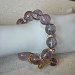 This is a bracelet featuring high-clarity amethyst, rose quartz, and citrine. It's an elegant look of pure peace.