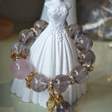 This is a bracelet featuring high-clarity amethyst, rose quartz, and citrine. It's an elegant look of pure peace.