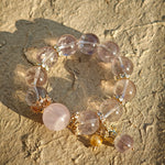 This is a bracelet featuring high-clarity amethyst, rose quartz, and citrine. It's an elegant look of pure peace.