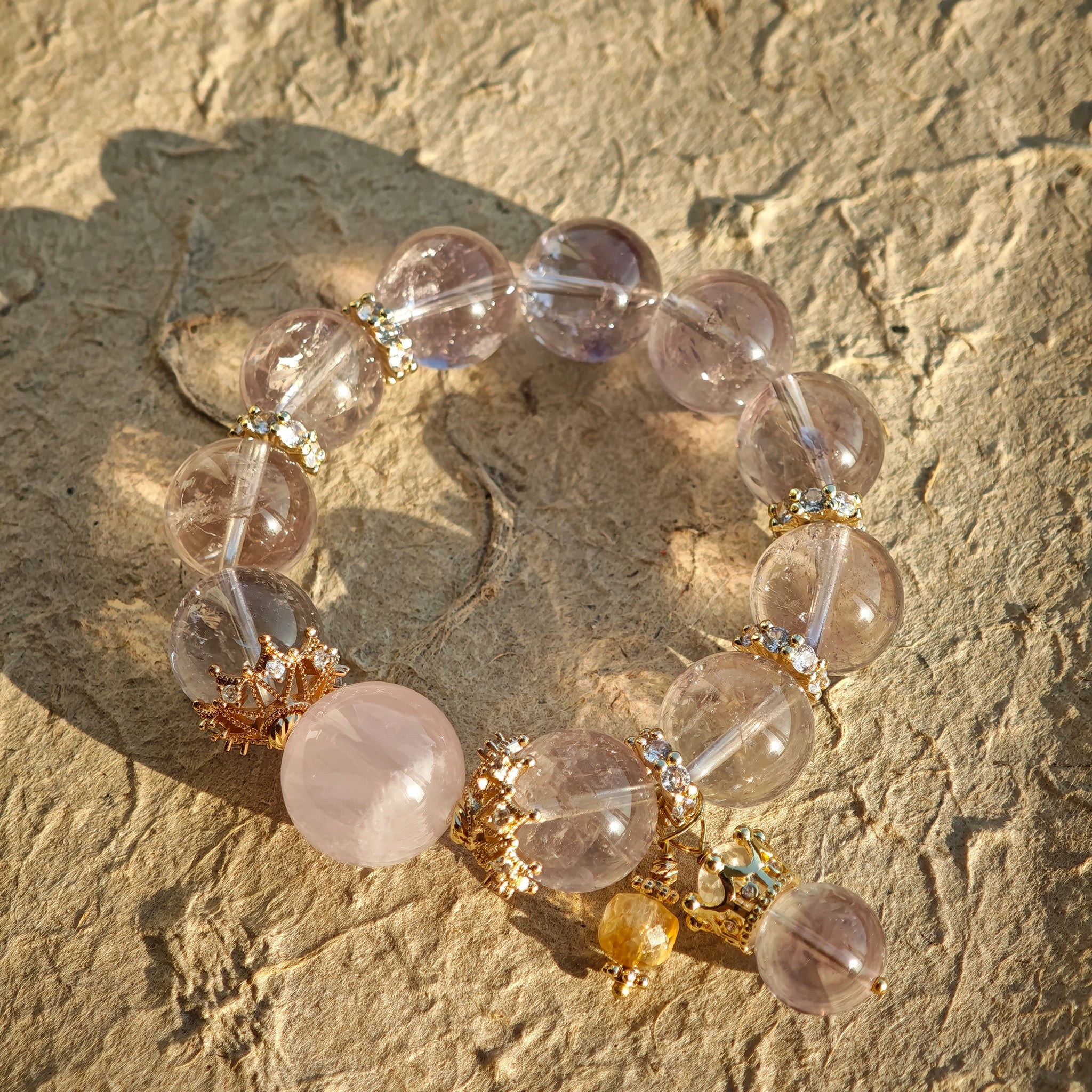 This is a bracelet featuring high-clarity amethyst, rose quartz, and citrine. It's an elegant look of pure peace.