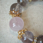 This is a bracelet featuring high-clarity amethyst, rose quartz, and citrine. It's an elegant look of pure peace.