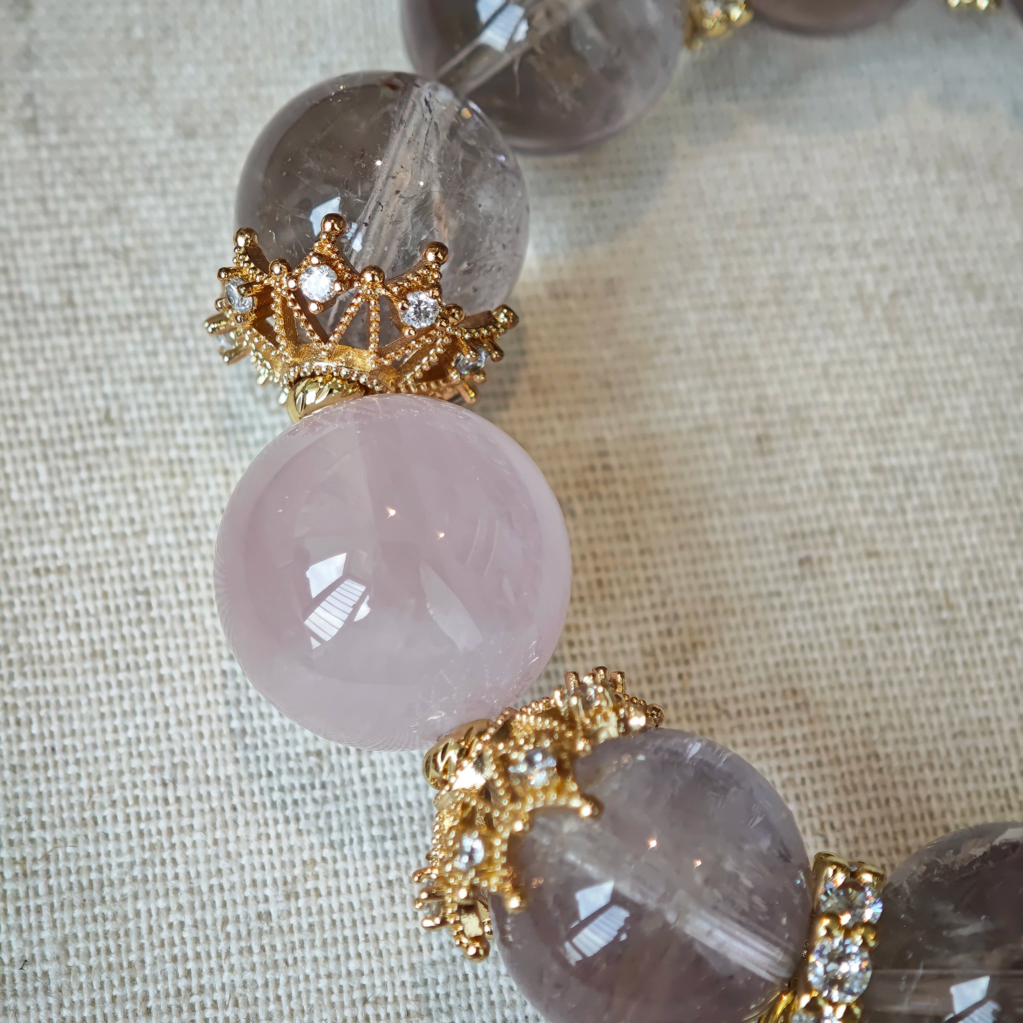 This is a bracelet featuring high-clarity amethyst, rose quartz, and citrine. It's an elegant look of pure peace.