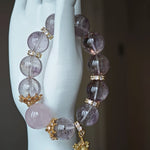 This is a bracelet featuring high-clarity amethyst, rose quartz, and citrine. It's an elegant look of pure peace.