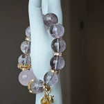 This is a bracelet featuring high-clarity amethyst, rose quartz, and citrine. It's an elegant look of pure peace.