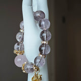 This is a bracelet featuring high-clarity amethyst, rose quartz, and citrine. It's an elegant look of pure peace.