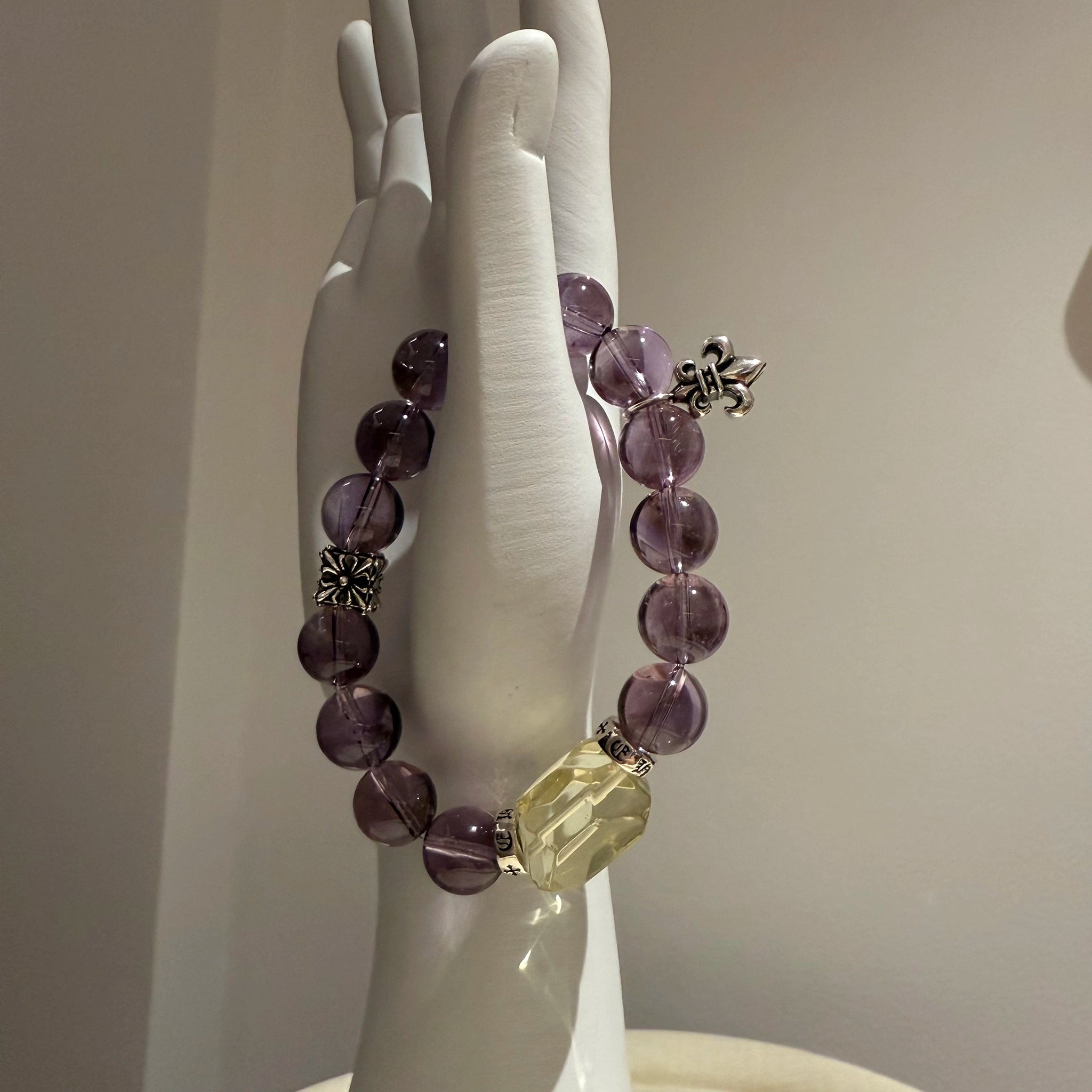 Let soothing amethyst crystals guard your peace while the solitary citrine sparks creativity—all on one star-kissed crystal bracelet.