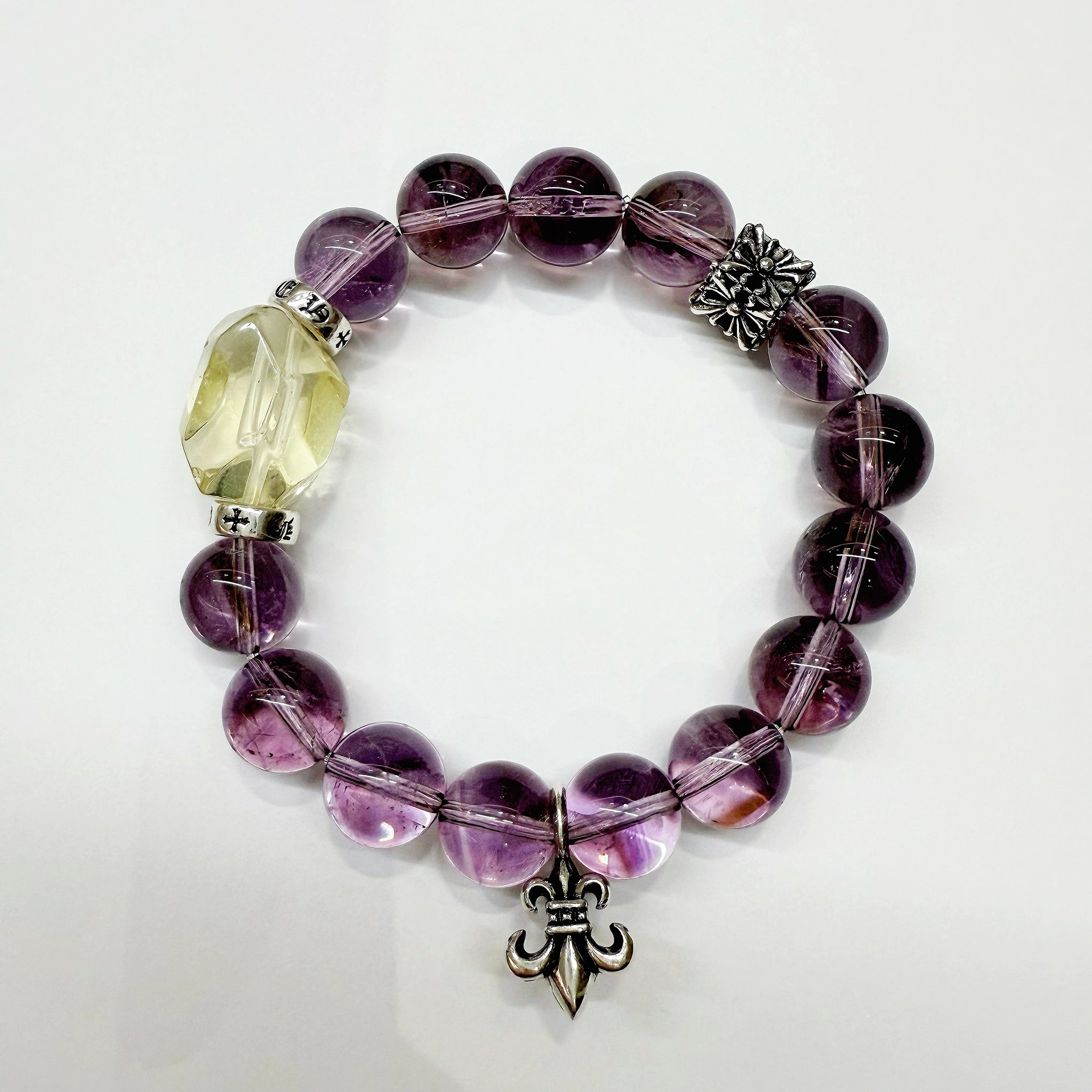 This crystal bracelet marries 14 tender amethyst beads with one radiant citrine sunbeam and star-like sterling spacers—pure purple-to-gold magic.