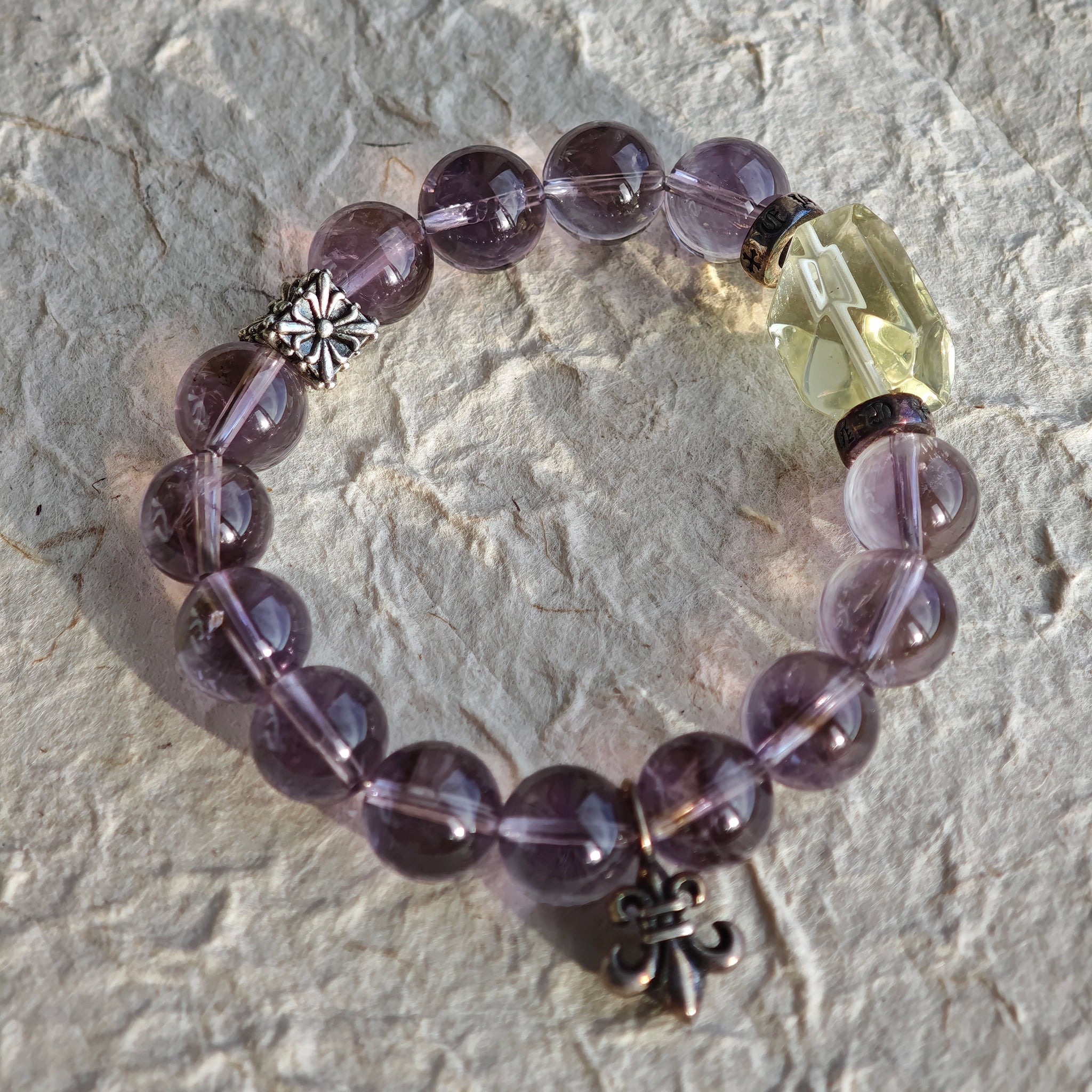 This is a crystal bracelet that consists of amethyst, citrine and chrome hearts spacers.